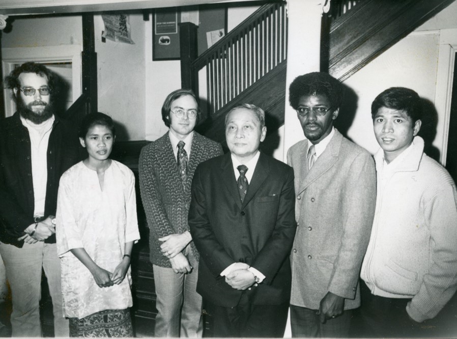 graduate students and a speaker pose at 102 West Ave