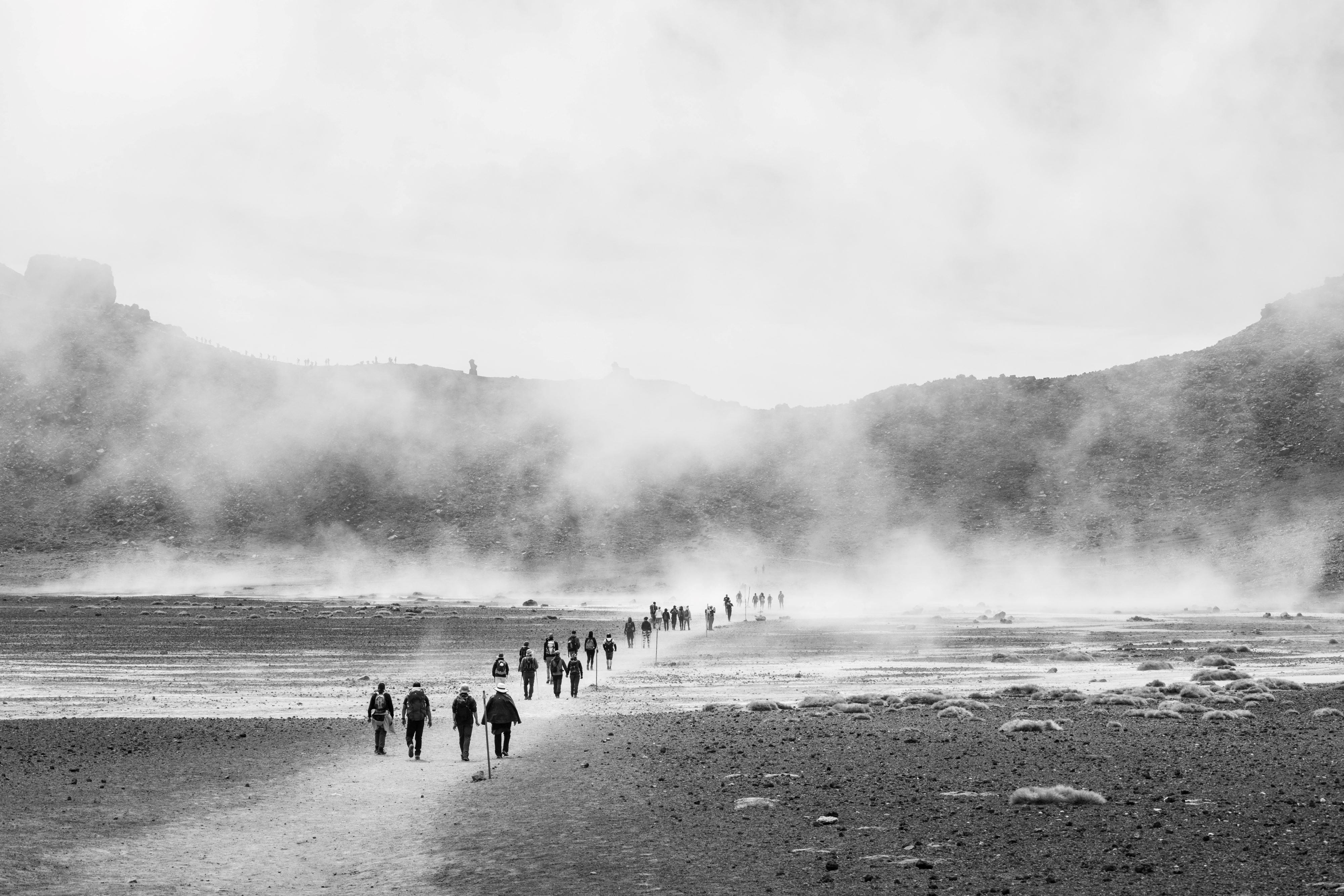 People walking across rocky terrain