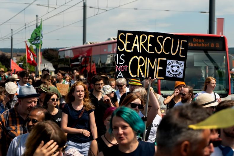 protestors on a street with signs