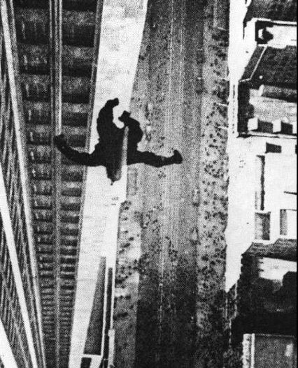 A still from the film King Kong vs Godzilla shows Kong tumbling headfirst down a skyscraper in black and white