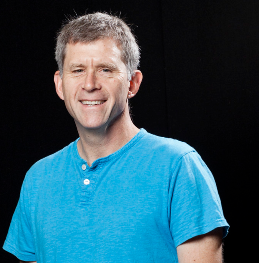 James Millward short cropped hair white wearing a blue shirt