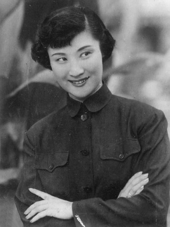 Chinese woman short bob hairstyle folded arms wearing a Mao collar jacket smiling b and w shot