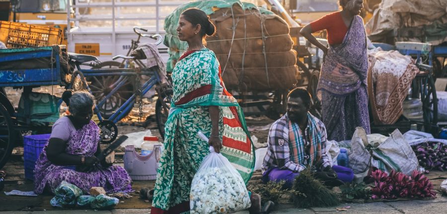 Woman walking in Koyambedu Market, Chennai, India