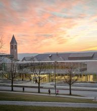 A landscape with a sunset and Cornell's iconic Clock Tower