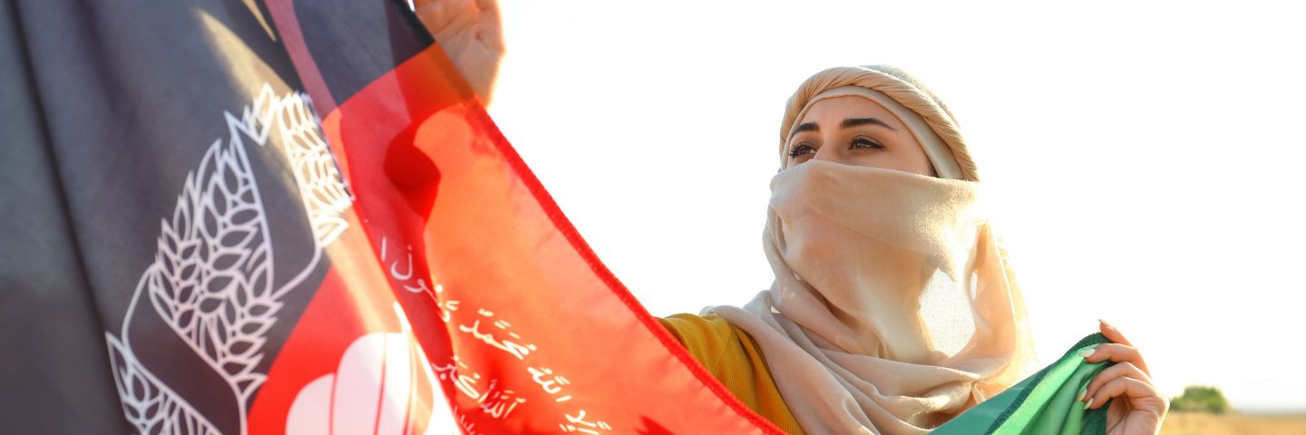 Muslim woman with flag of Afghanistan