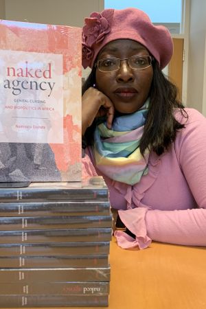 Naminata Diabate with a stack of her book