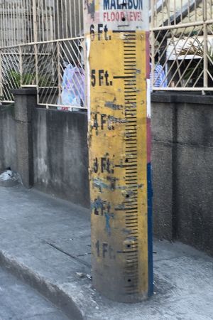 Cement pole painted with flood measurement markers in the Philippines