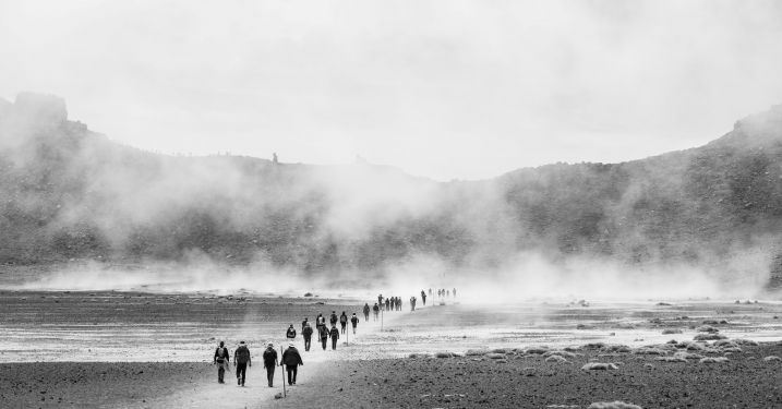 People walking across rocky terrain