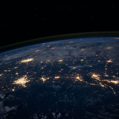 top half of earth at night with lights 