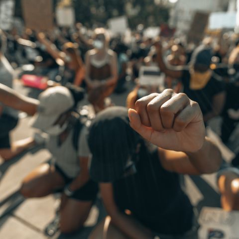 Protesters take knee with fists in the air