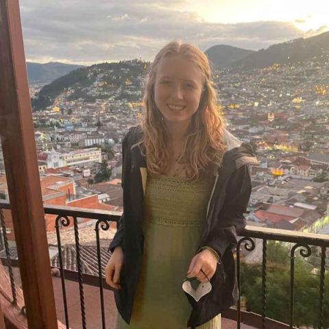 Hannah standing on a balcony overlooking Quito.