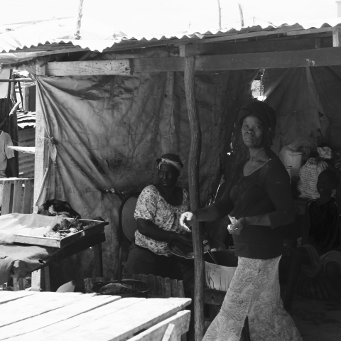 A woman operating a food stand at the border.