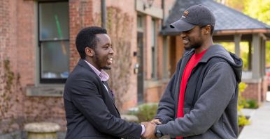 Laidlaw scholars smile and shake hands.