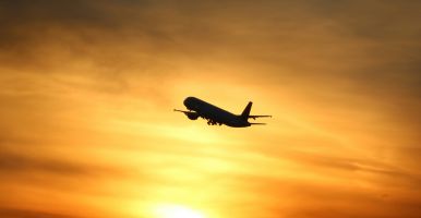 plane flying at sunset