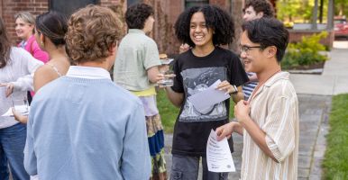 Laidlaw scholars chat in a group at a reception.